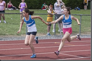 Bronagh Walsh takes the baton from Caitlin O'Sullivan to win the U14 girls All Ireland title in the 4x100m